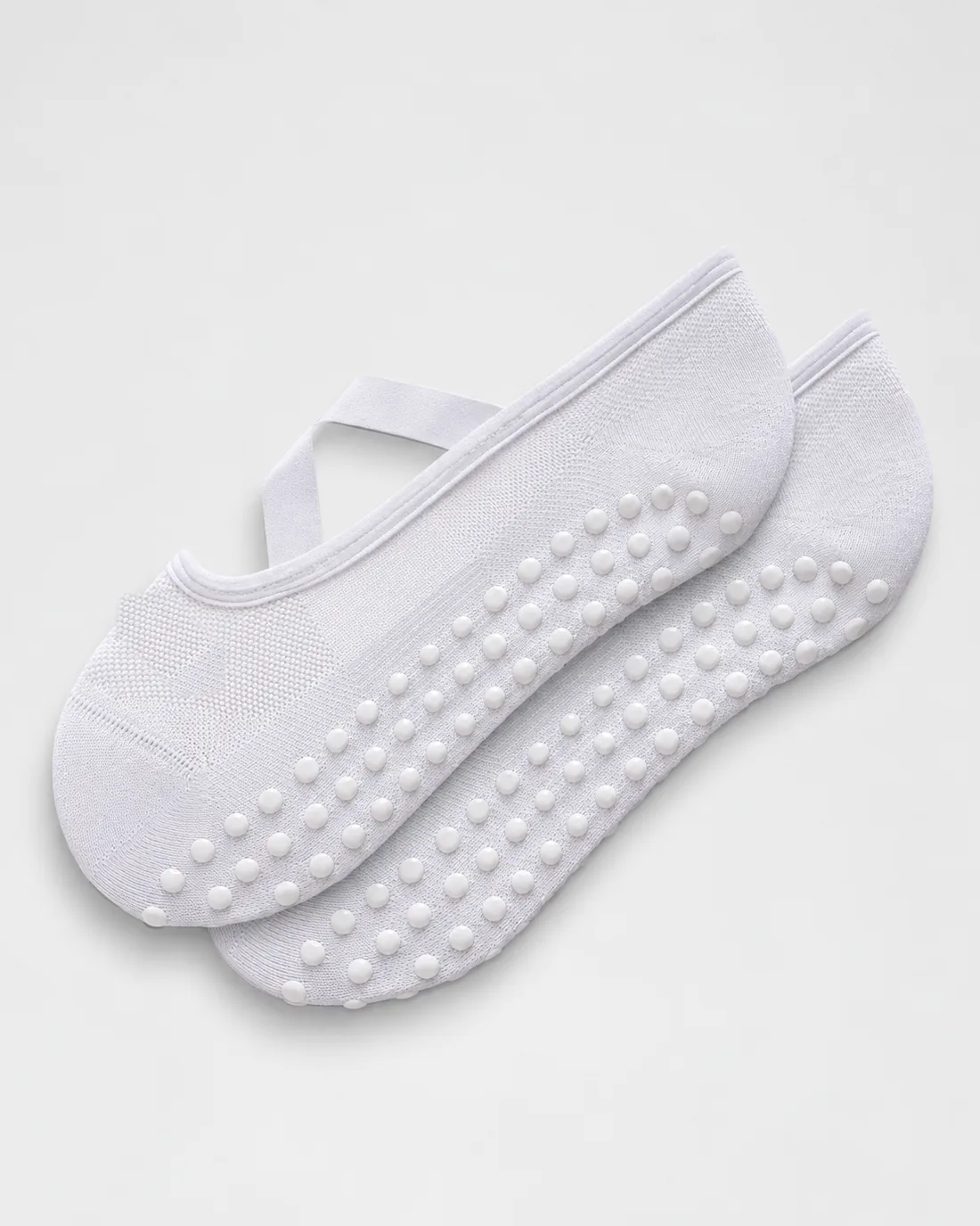 White strappy grip sock with criss-cross strap and silicone dots