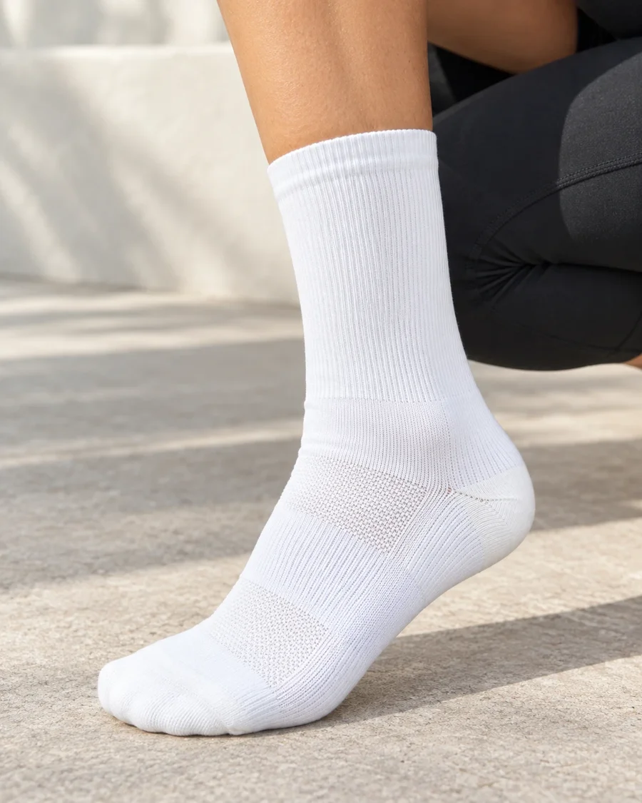 White running socks worn outdoors, mesh zones on the instep